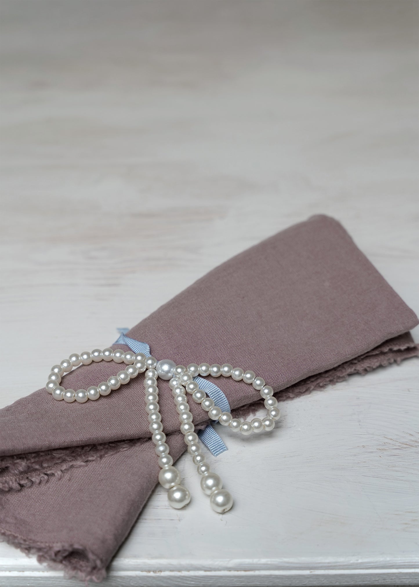 Pearl-bow with blue ribbon