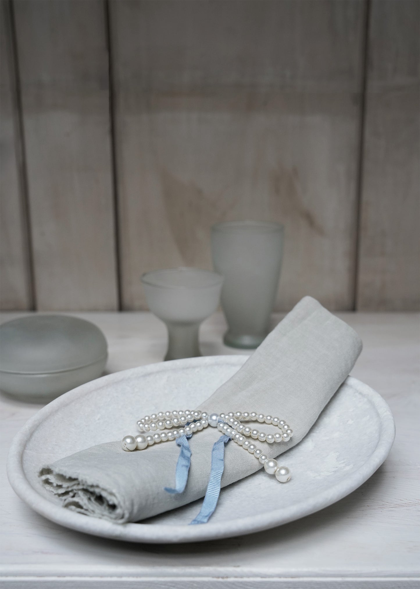 Pearl-bow with blue ribbon