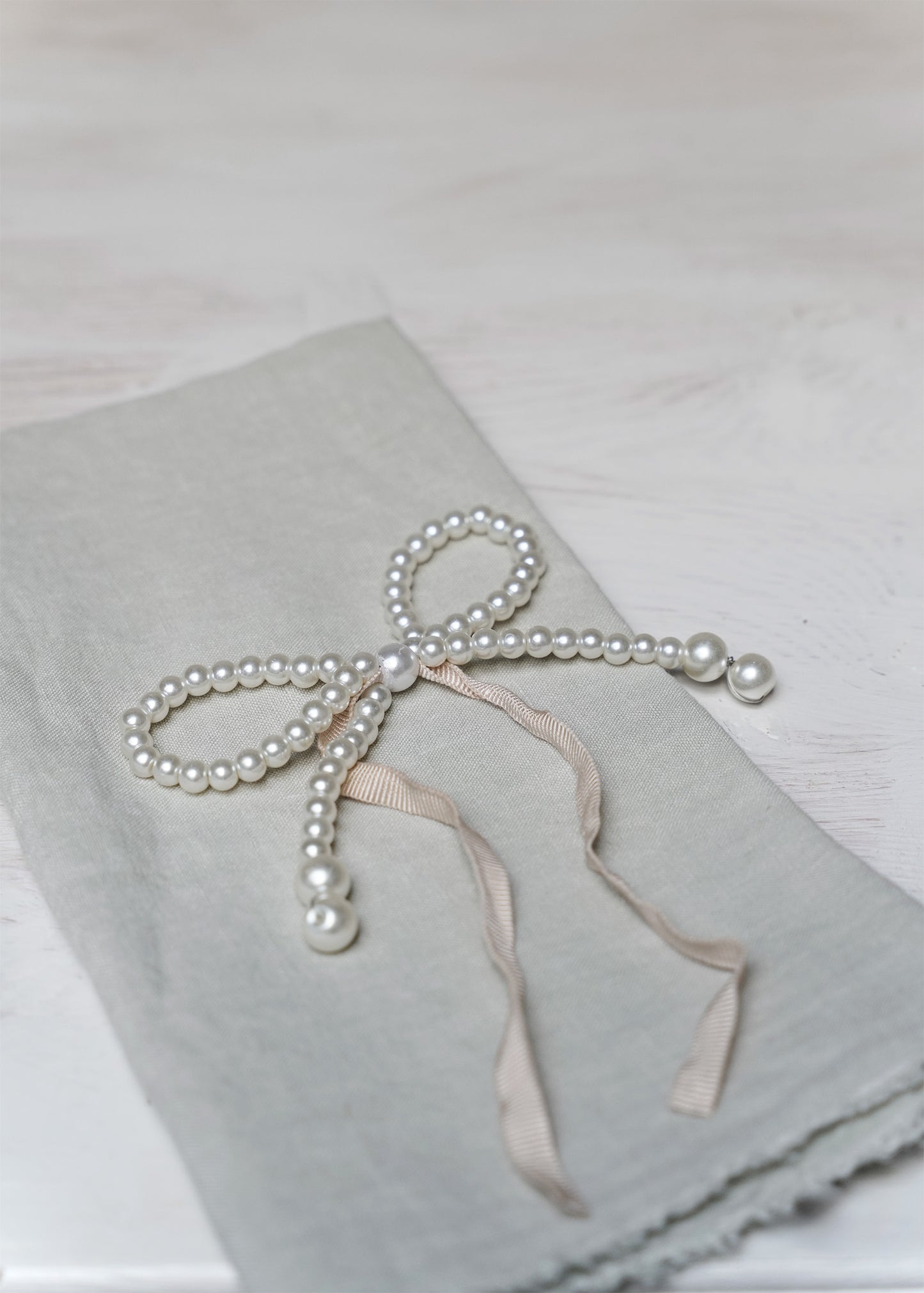 Pearl-bow with pink ribbon