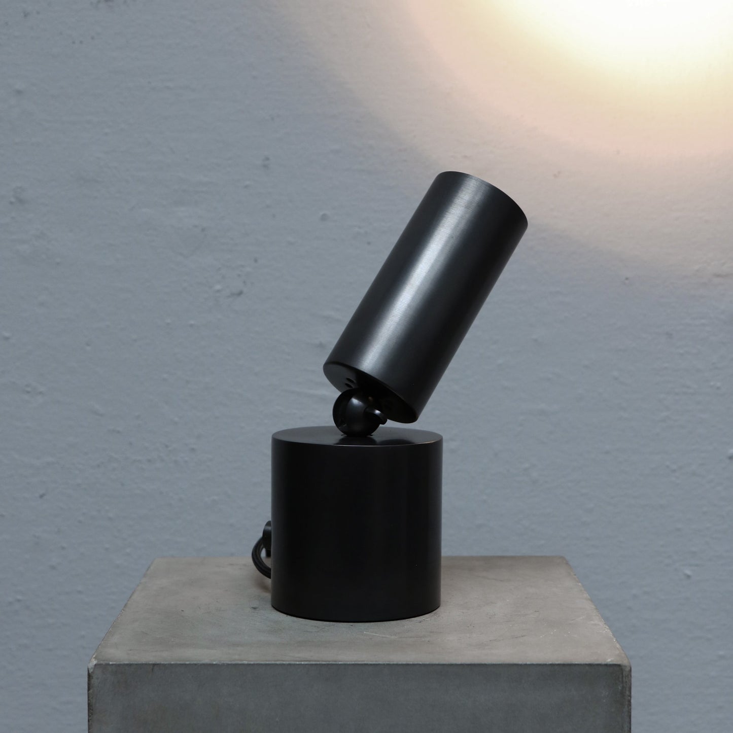 Cylinder uplight in blackened brass by design studio Apparatus
