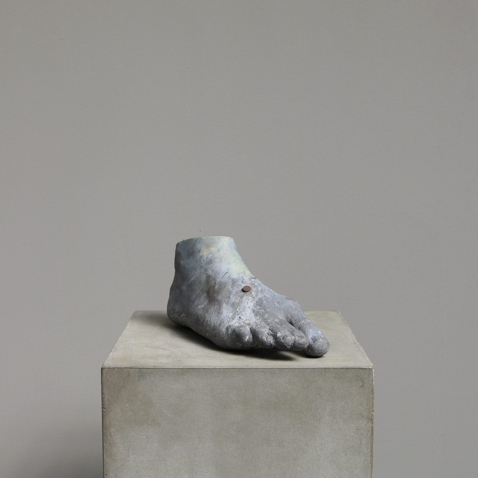 Begot (23517B) 2017 is a sculptural piece of a foot made by the Danish artist Kaare Golles. The sculpture is made in patinated lead.