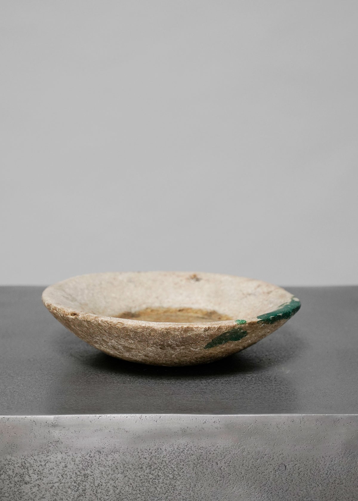 Beige stone bowl w green paint stroke
