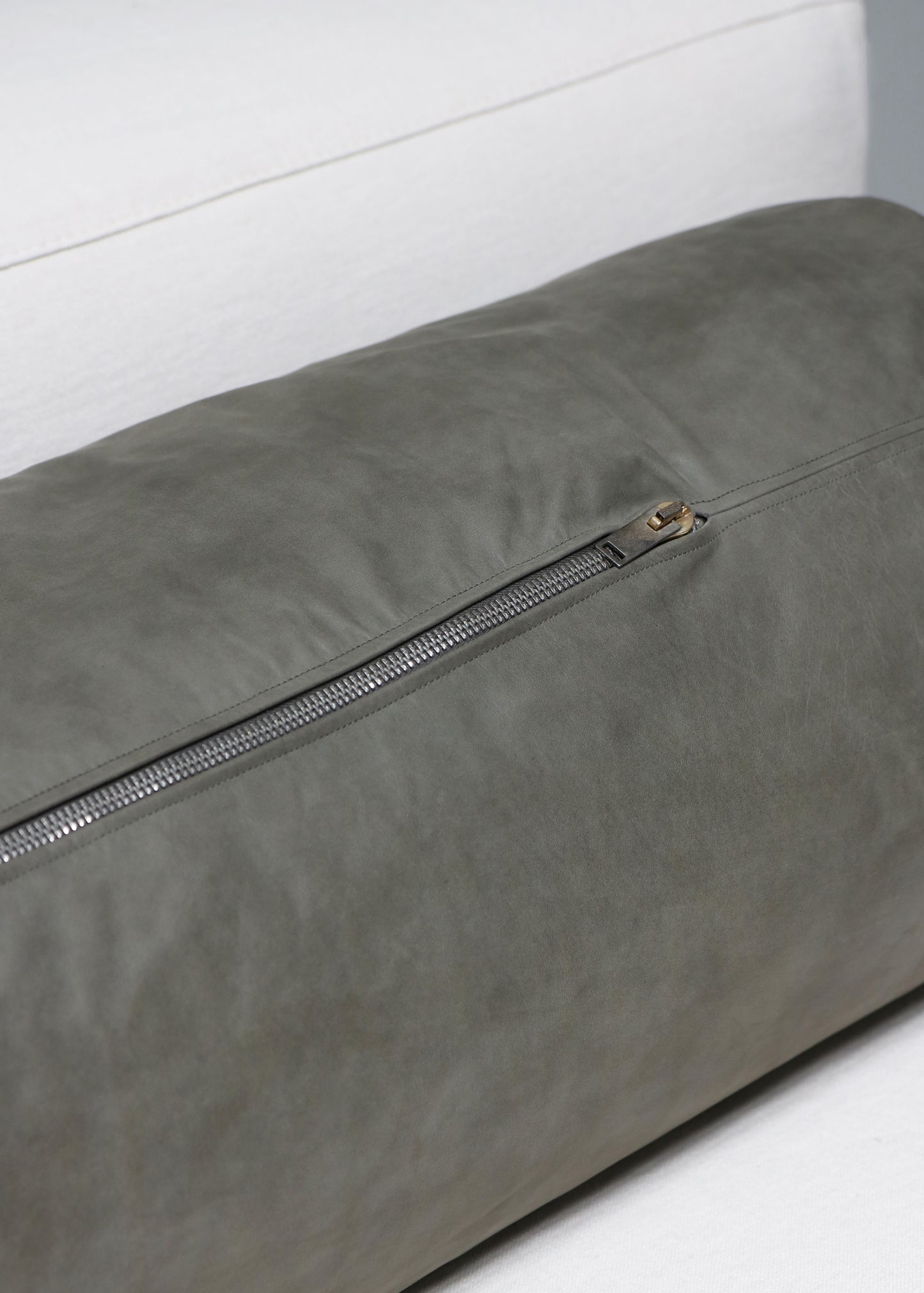 Elongated leather cushion