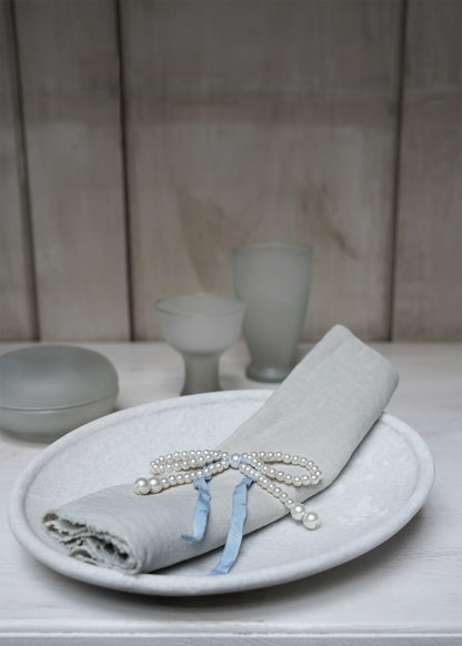 Pearl-bow with blue ribbon