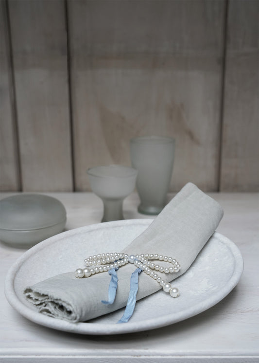 Pearl-bow with blue ribbon