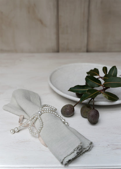 Pearl-bow with pink ribbon