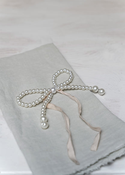 Pearl-bow with pink ribbon