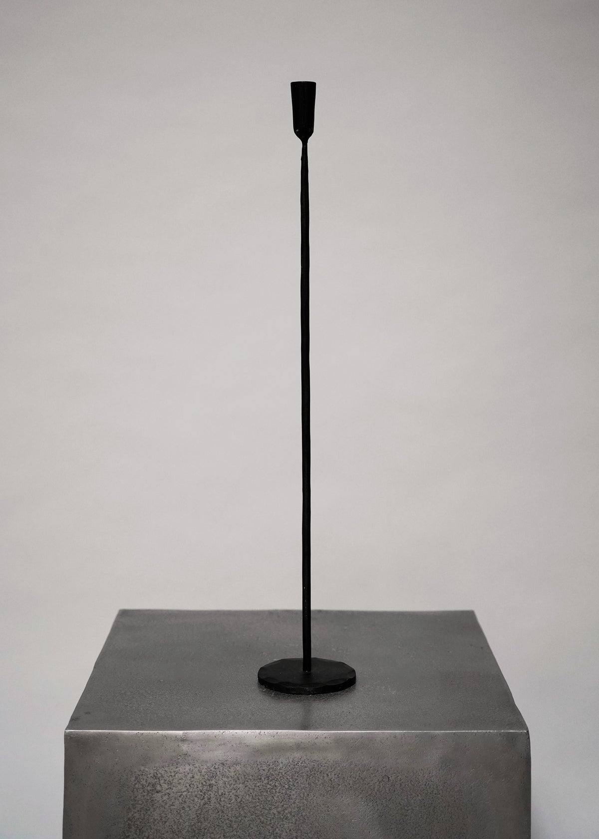 large blackened iron candle holder