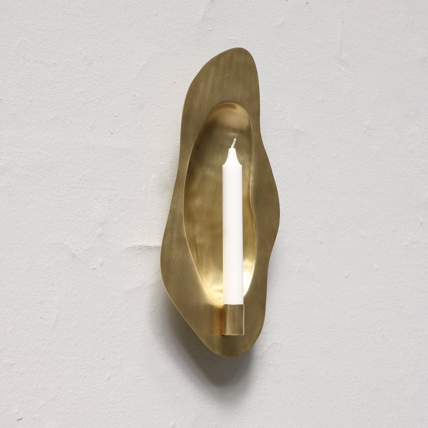Brass candle holder designed by Christian+Jade Reflecting Flame