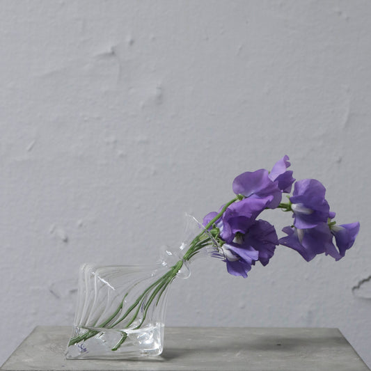 Mouth blown glass vase for a single flower. Elegant interior design.